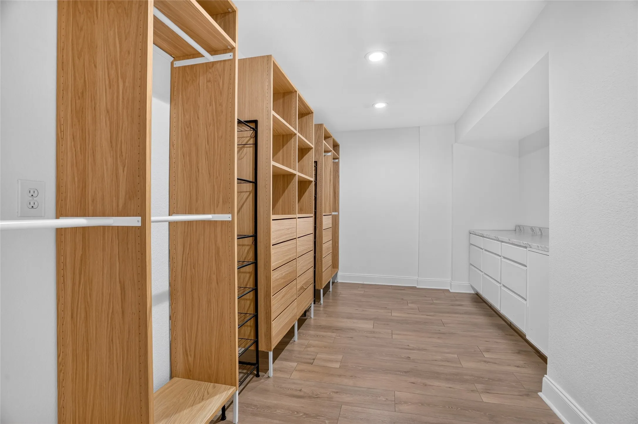 Custom wood-finish closet system with integrated drawers and shelving