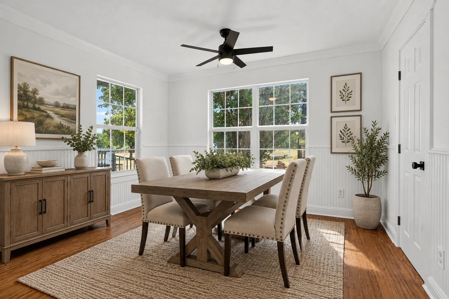 Hardwood-finish flooring, white beadboard wainscoting, and crown molding. Virtually staged using AI.