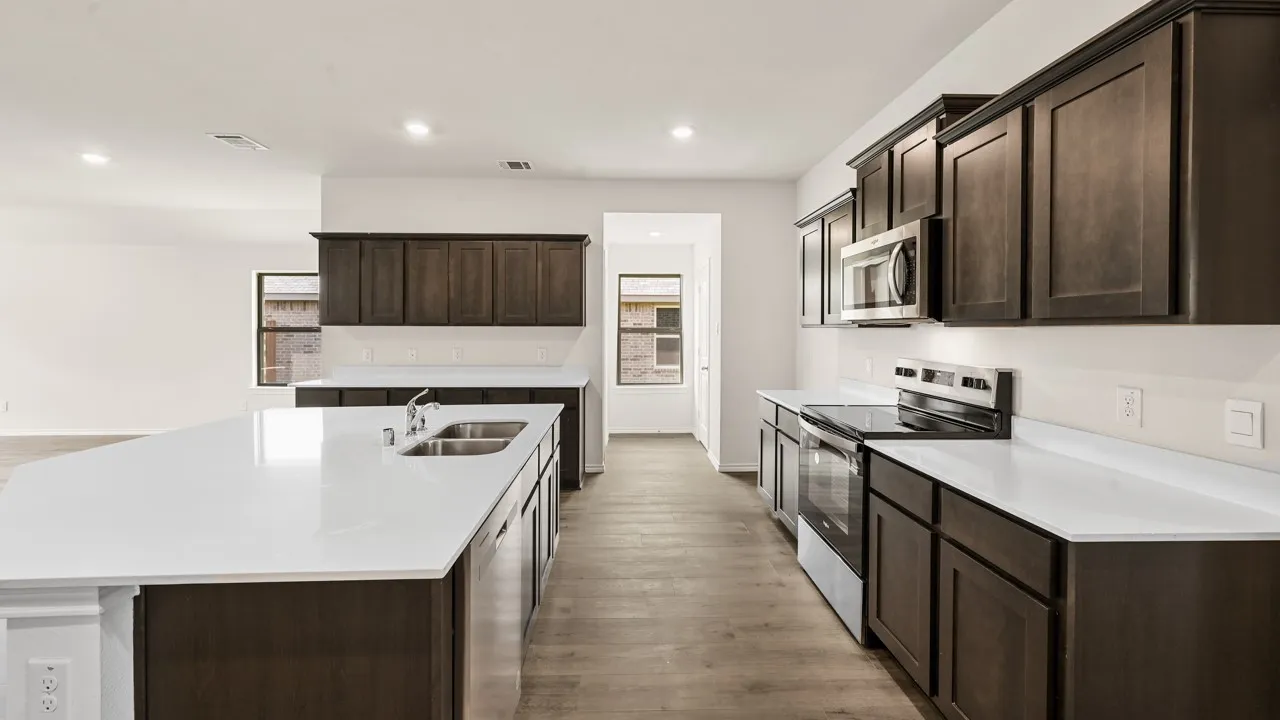 Kitchen featuring dark wood-finish cabinetry, white countertops, stainless steel appliances, and wood-finish flooring