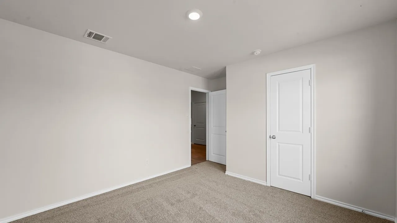 Neutral tone wall paint, carpet flooring, and white trim