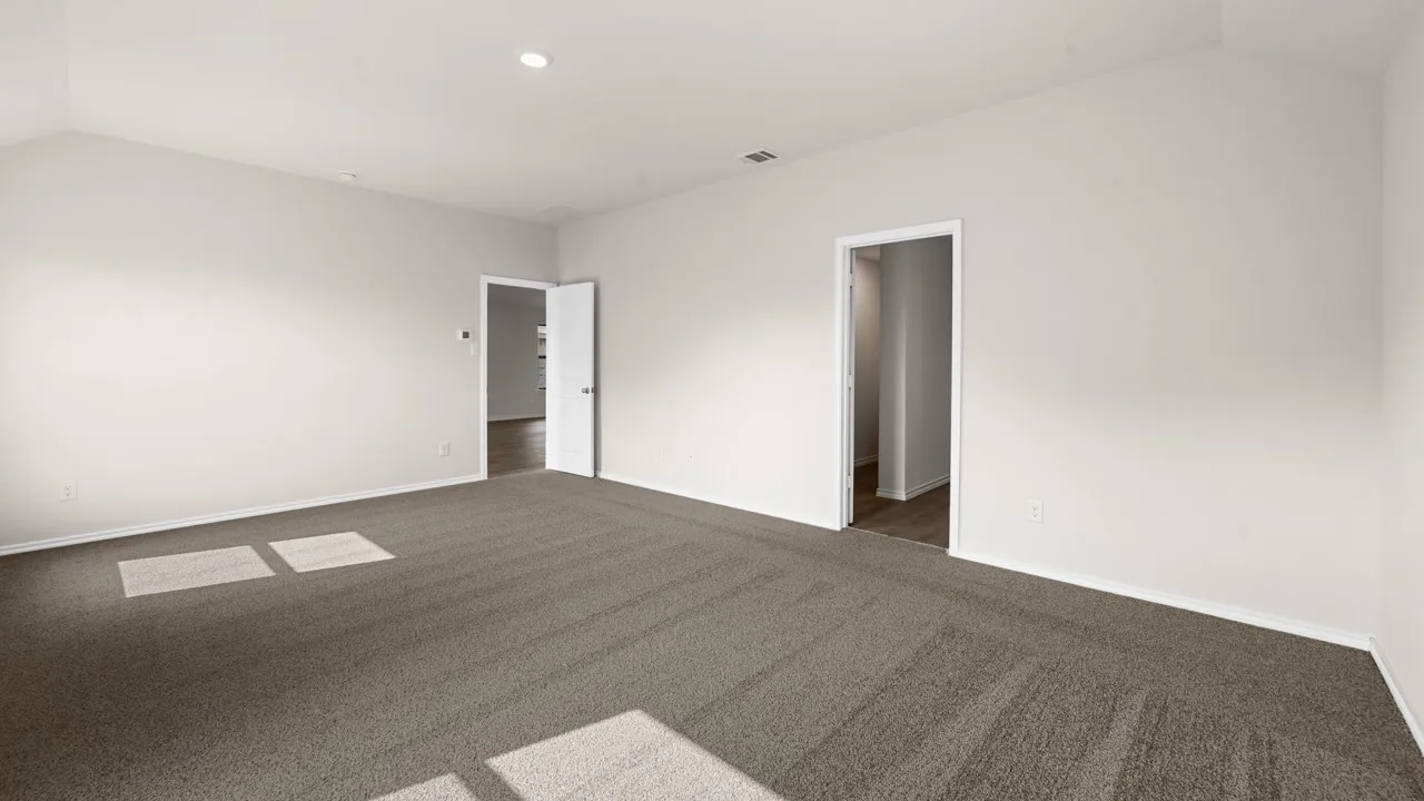 Expansive room with neutral carpeting and light-toned walls