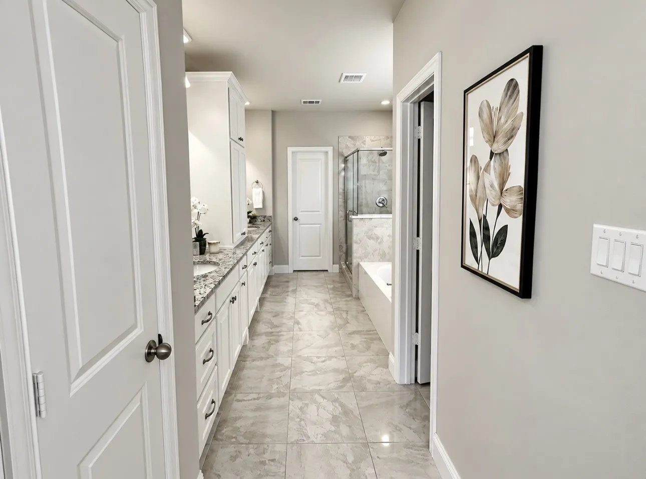 Dual vanity with under-mount sinks, granite countertops, and white cabinetry