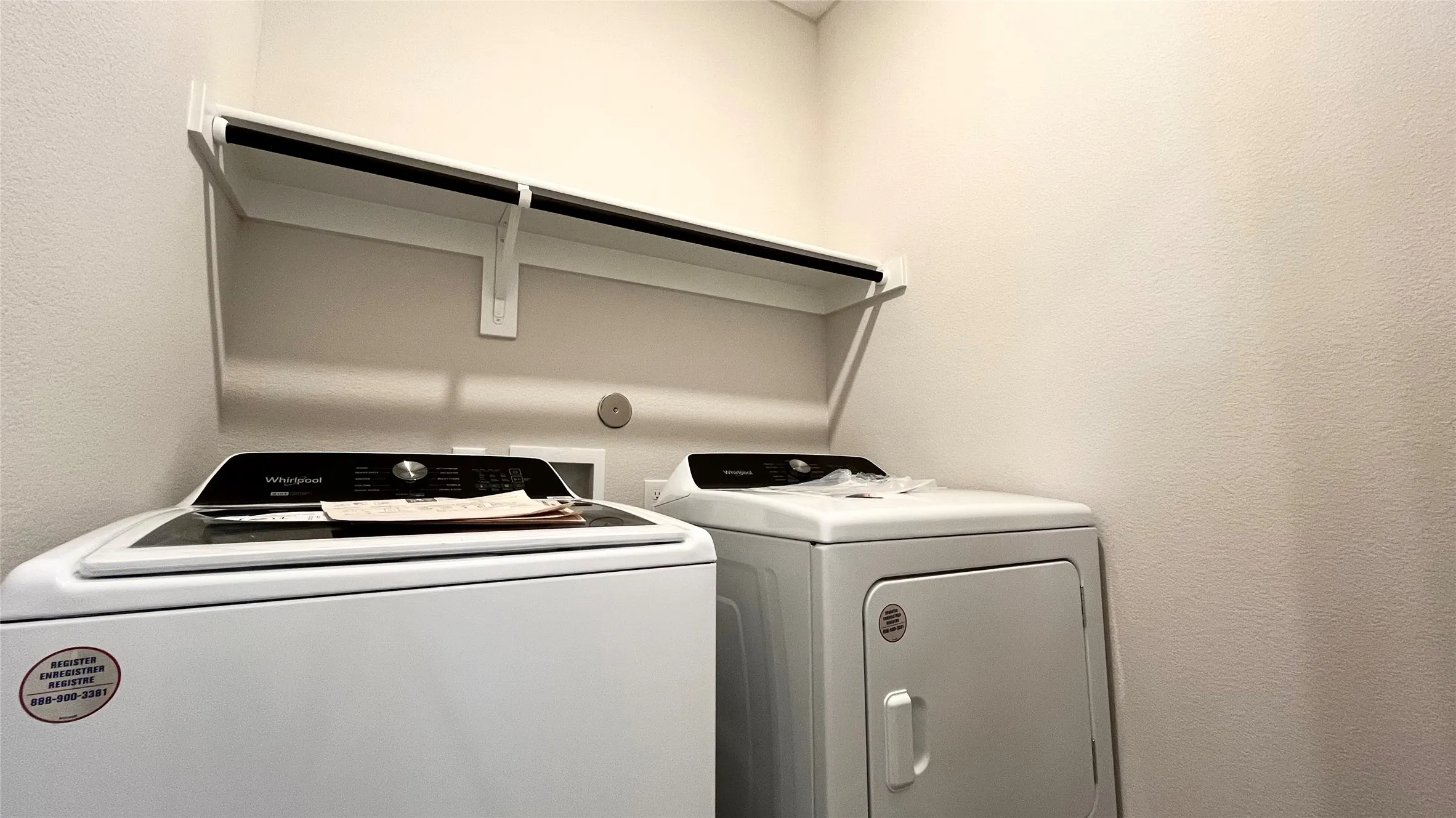Built-in shelving with hanging rod, and a full-size washer and dryer