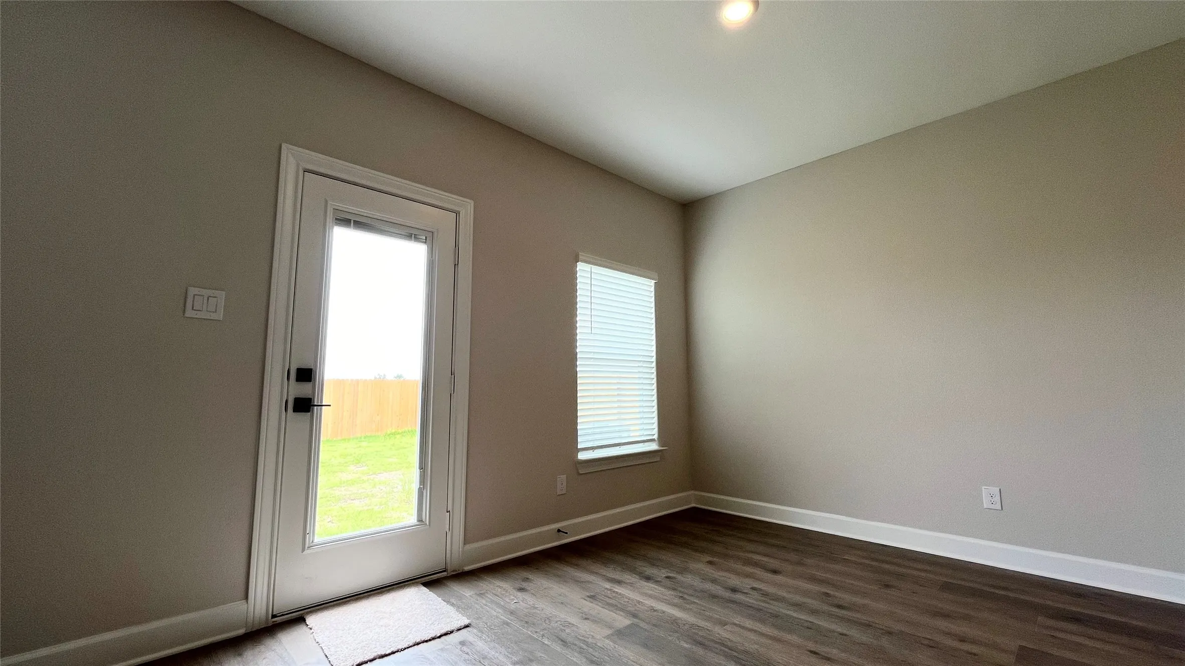 Wood-finish flooring, recessed lighting, and neutral wall tones