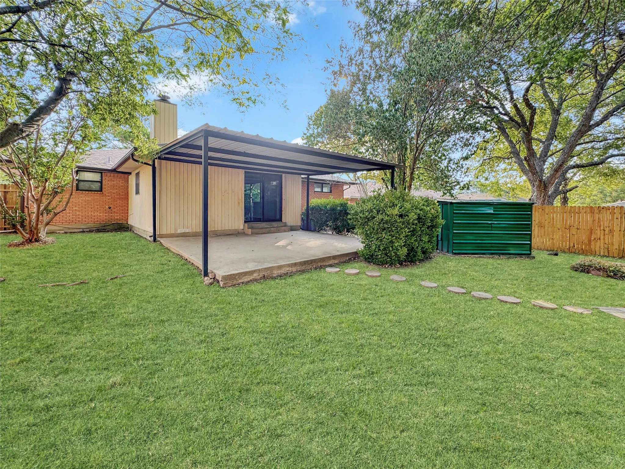 Huge backyard, covered patio, and storage unit