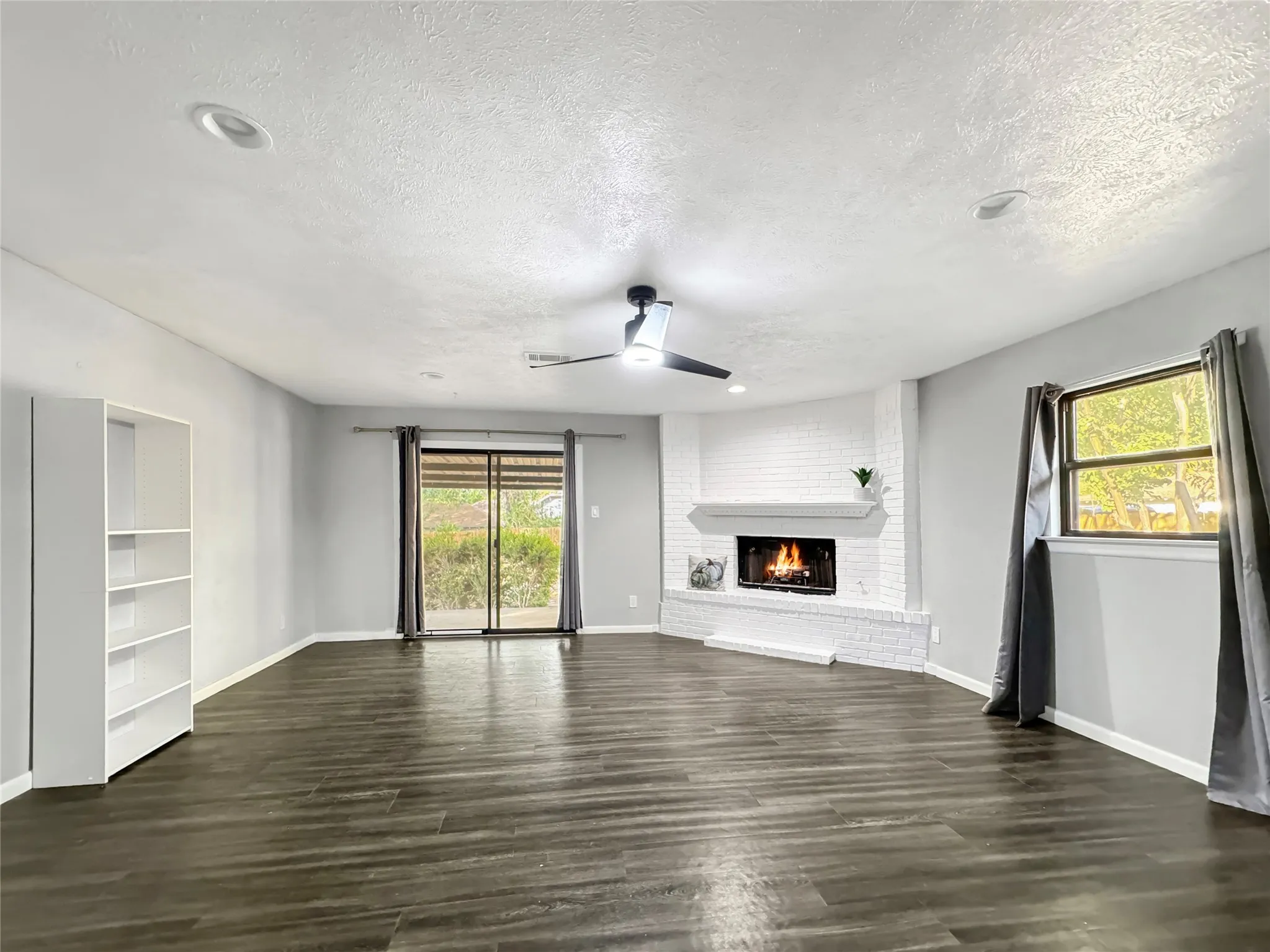 Double Doors open to a patio and a huge backyard.