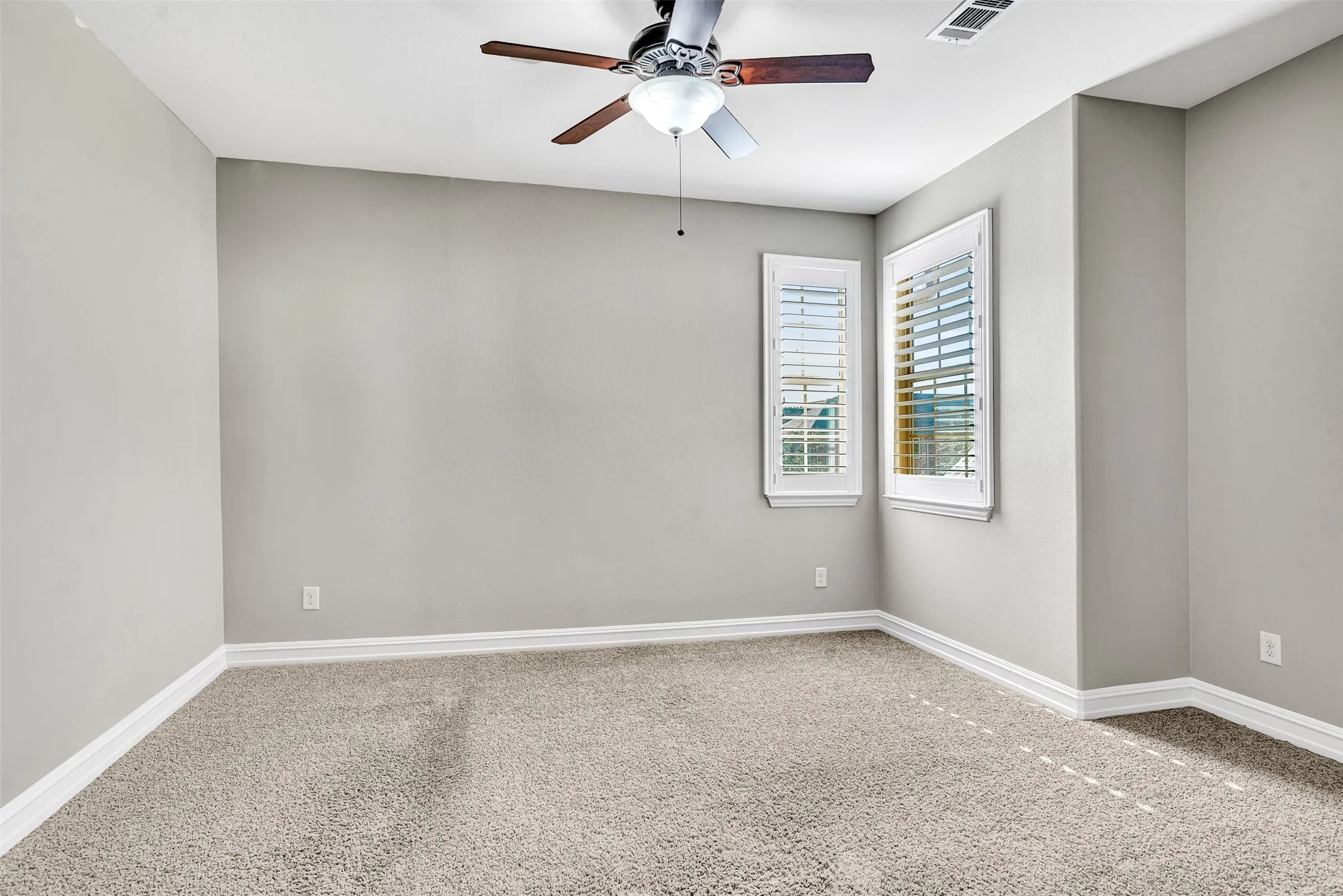 Bedroom 2 has Plantation shutters on the windows and a large walk-in closet.