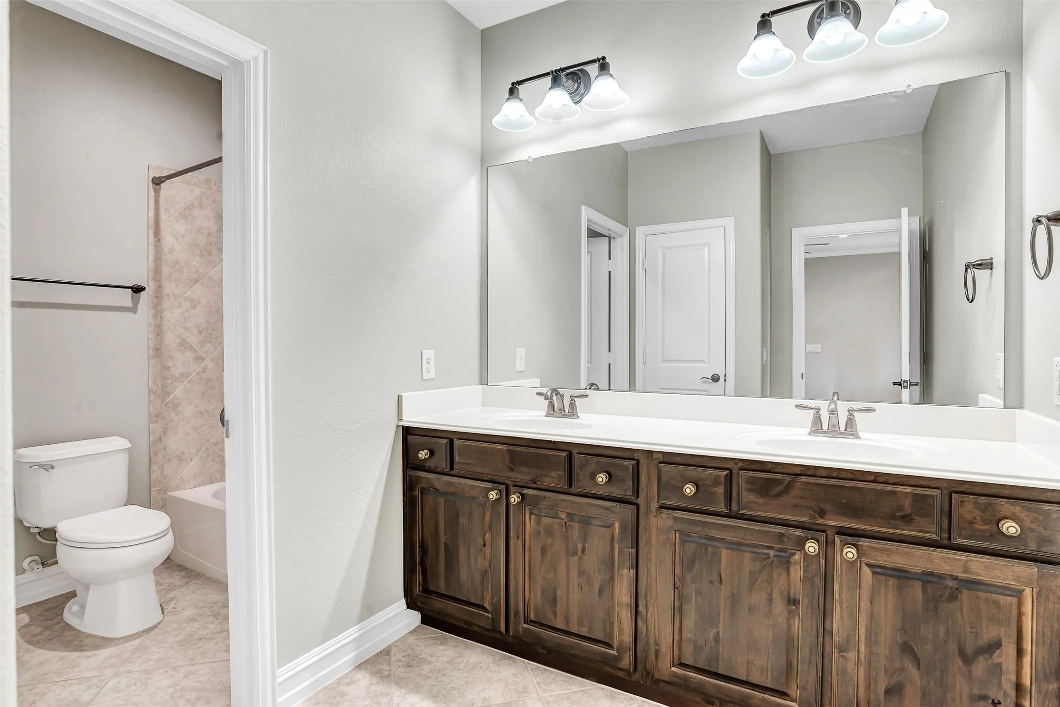 The full bath upstairs has a large vanity with dual sinks and a separate tub/shower area so more than one person can be using the bath at the same time, each with privacy!