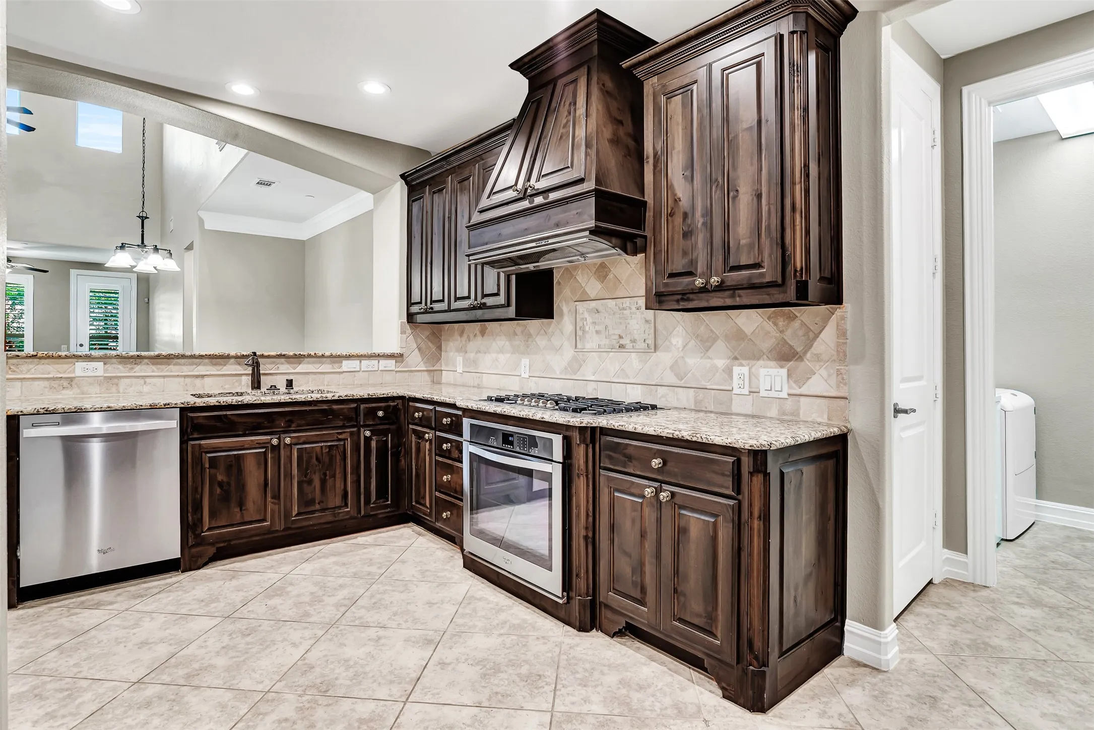 The kitchen has a large pantry, plus the utility room and access to the 2 car garage.