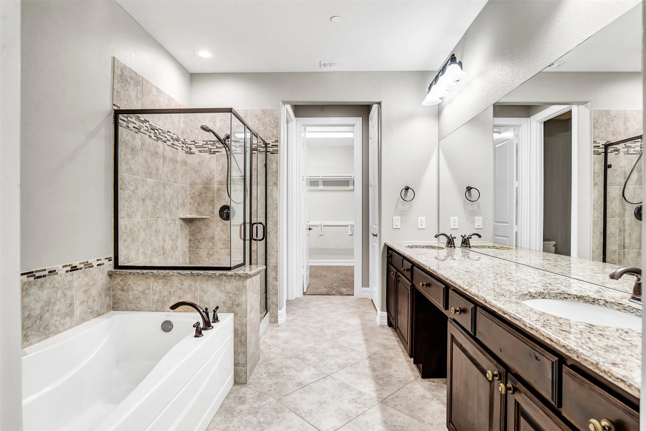 This townhome is full of surprises, including this large master bath! Dual sinks in a large vanity, separate tub and shower plus a HUGE walk-in closet and a linen closet!