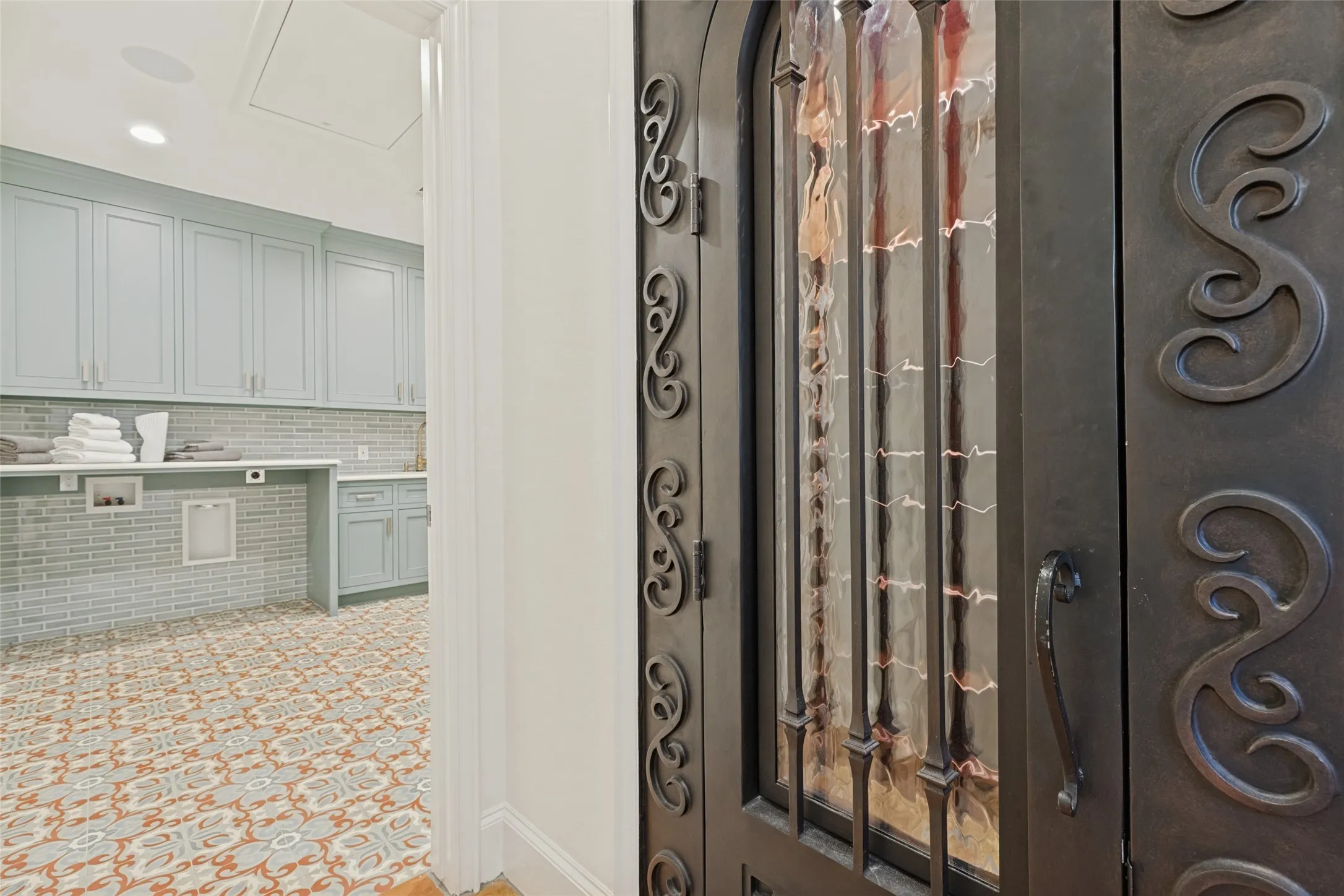 Wrought iron door with decorative glass panels