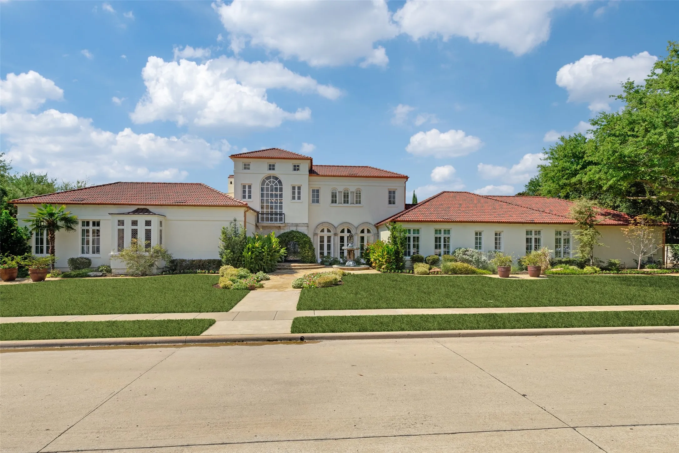 Mediterranean-inspired architecture with a stucco exterior and terracotta tile roofing