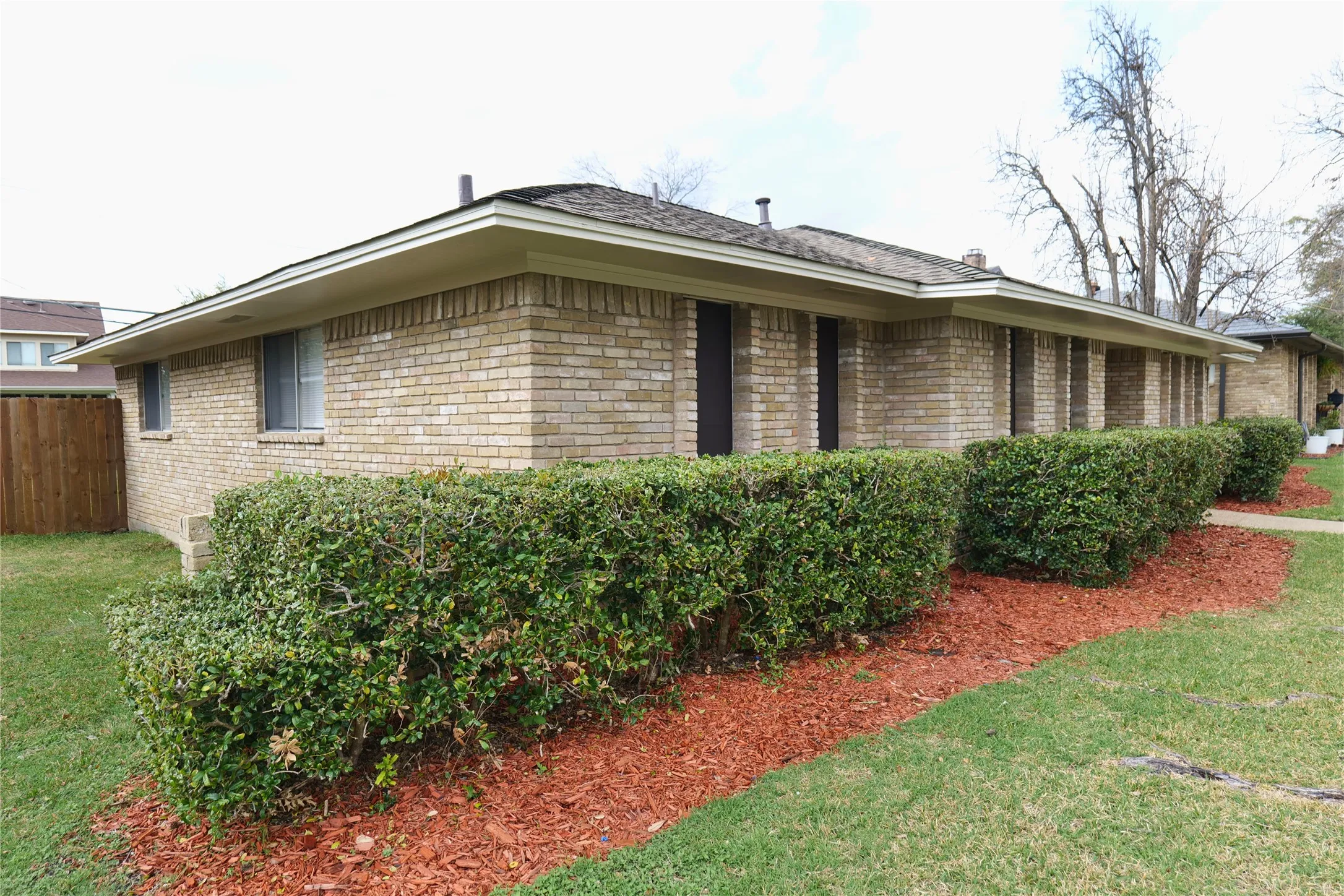 Brick exterior construction featuring multiple windows