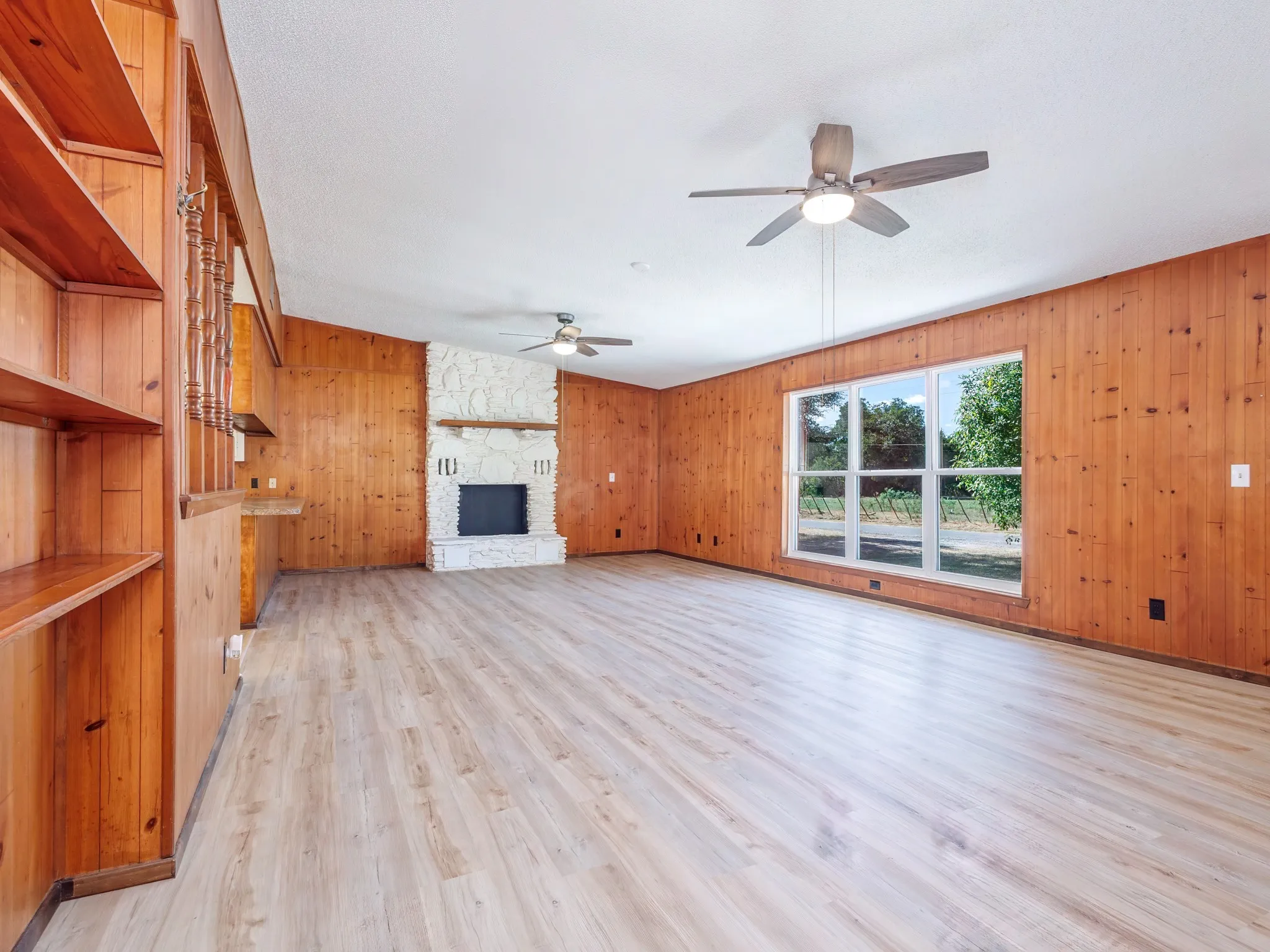 Large living room includes fireplace.  The fireplace is no longer wood burning.  The vinyl floor was laid in 2026