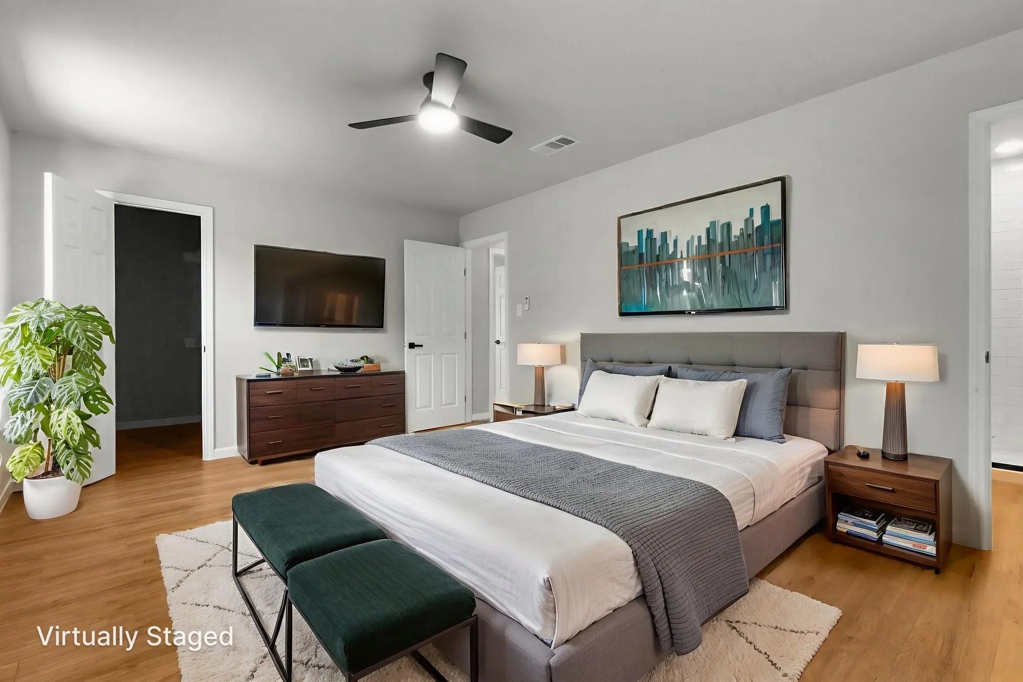 Wood-finish flooring throughout, modern ceiling fan with integrated lighting, and neutral wall tones