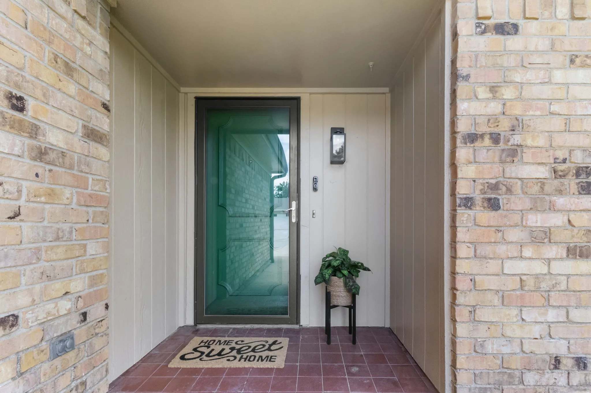 Brick and siding exterior with a covered entry