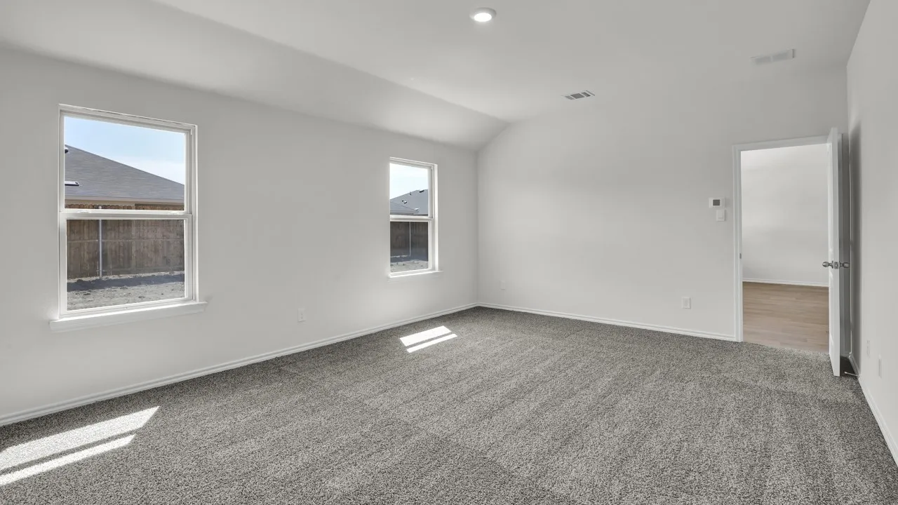 Vaulted ceiling with recessed lighting, light gray wall paint, and gray carpet flooring