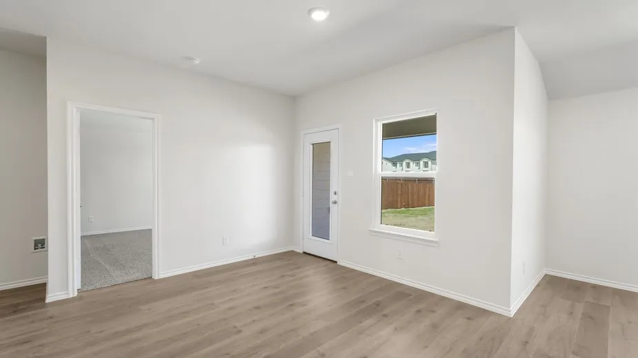 Wood-finish flooring, white walls, and a white trim throughout