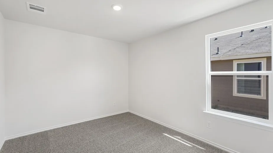Recessed lighting, white walls, gray carpet, and a white-framed window