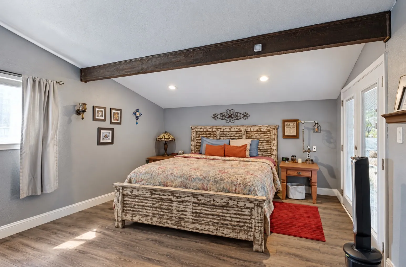 Vaulted ceiling featuring an exposed beam, wood-finish flooring, recessed lighting, and double French doors with transom windows