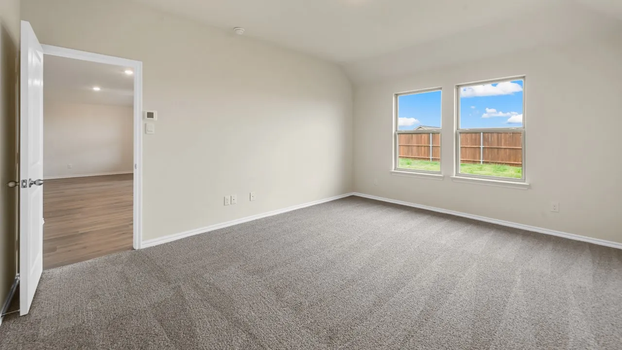Light gray carpeting, white walls, and dual pane windows