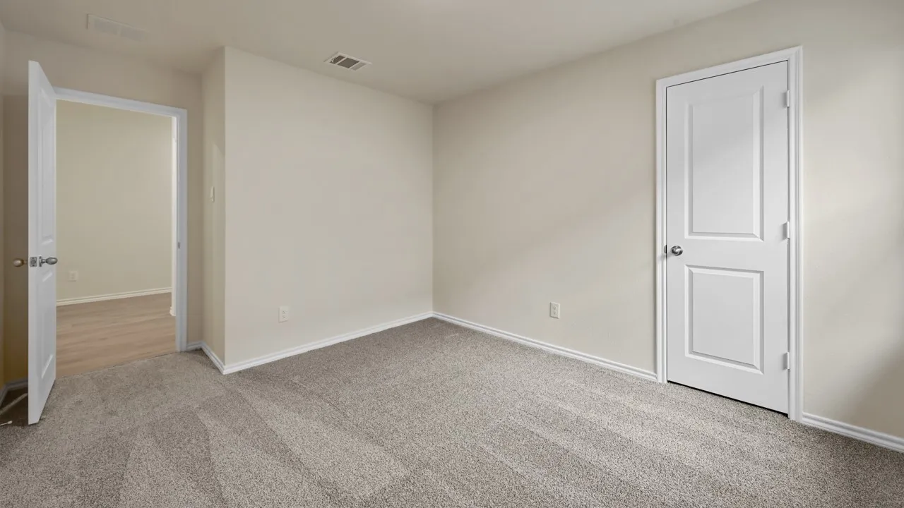 Light-colored walls, carpeted flooring, and white trim