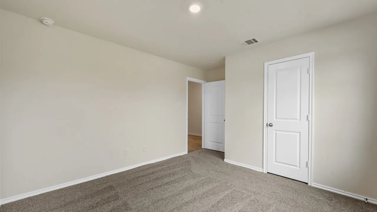 Neutral tone wall paint, light gray carpet flooring, recessed ceiling lighting, and white trim