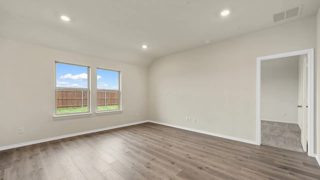 Recessed ceiling lighting, wood-finish flooring, two large windows, white trim, and light wall finishes