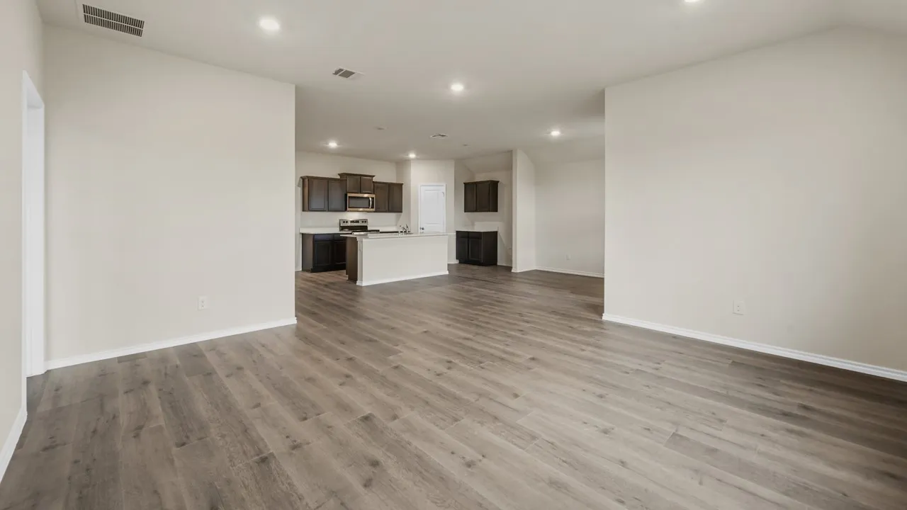 Wood-finish flooring throughout, recessed lighting, and a kitchen featuring dark wood cabinetry, a built-in microwave, and an island