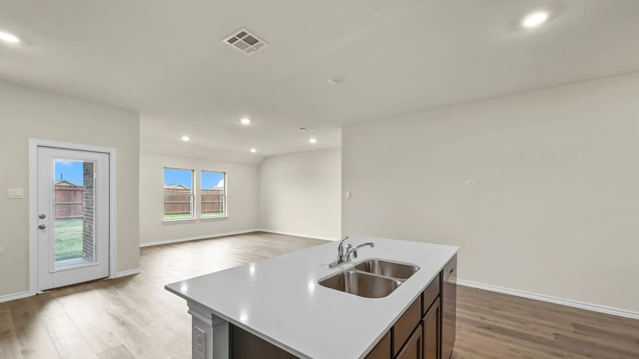 Kitchen island with a dual basin sink and stone countertop
