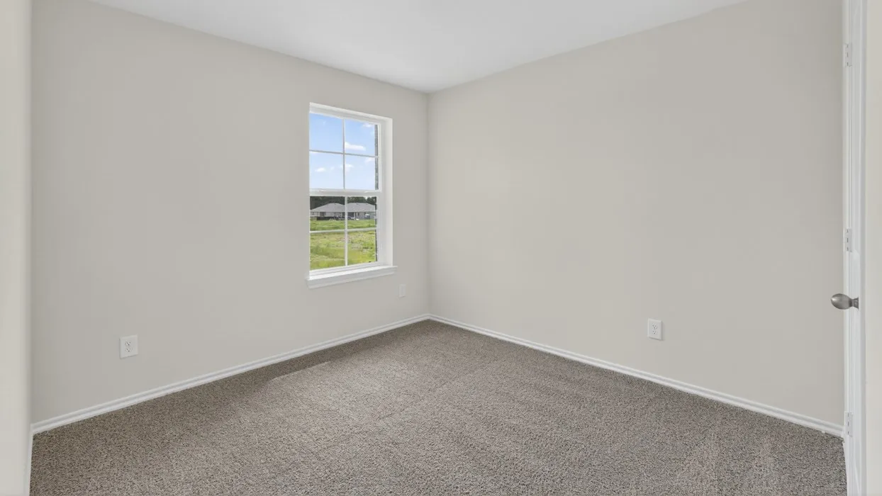 Neutral wall color, carpet flooring, and a single window with white trim