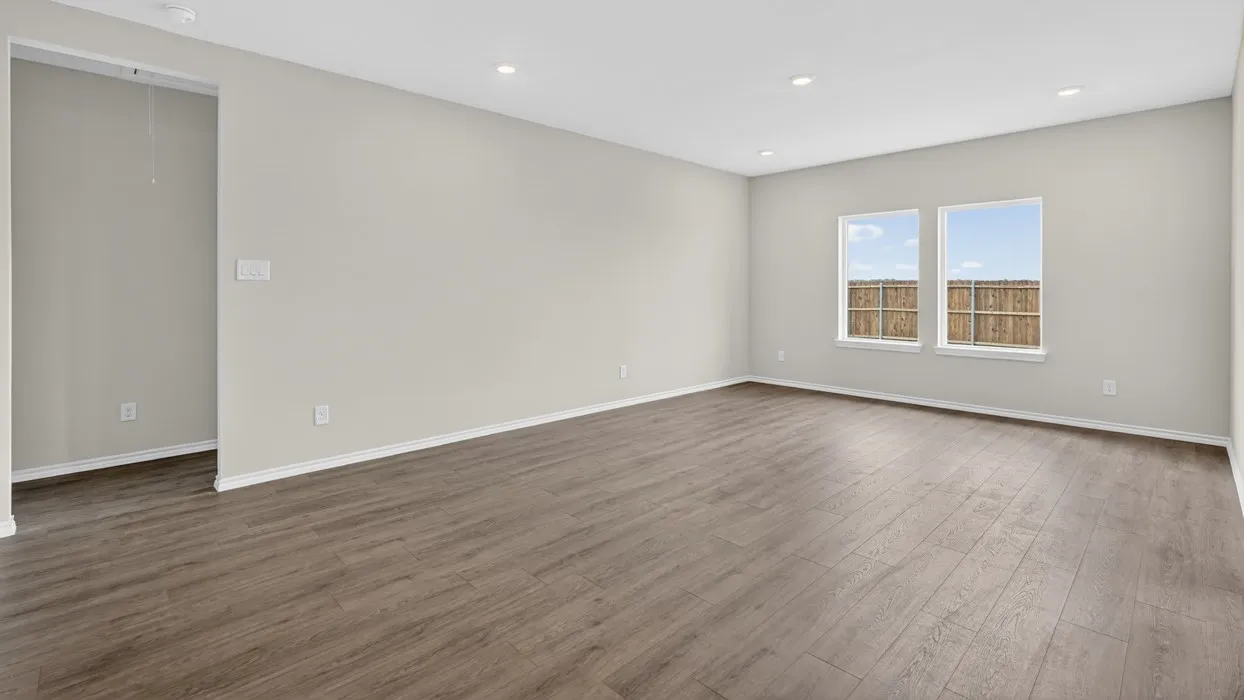 Wood-finish flooring, recessed lighting, and light-toned walls
