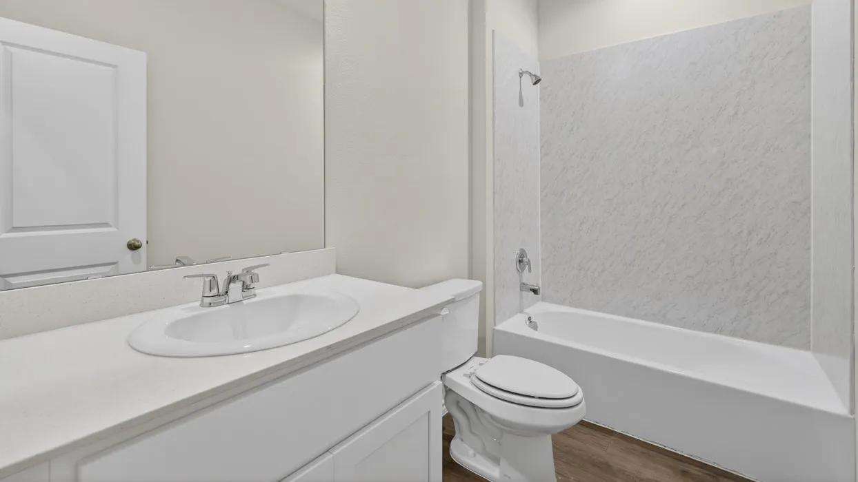 White vanity with an integrated sink, polished chrome faucet, and a large wall-mounted mirror
