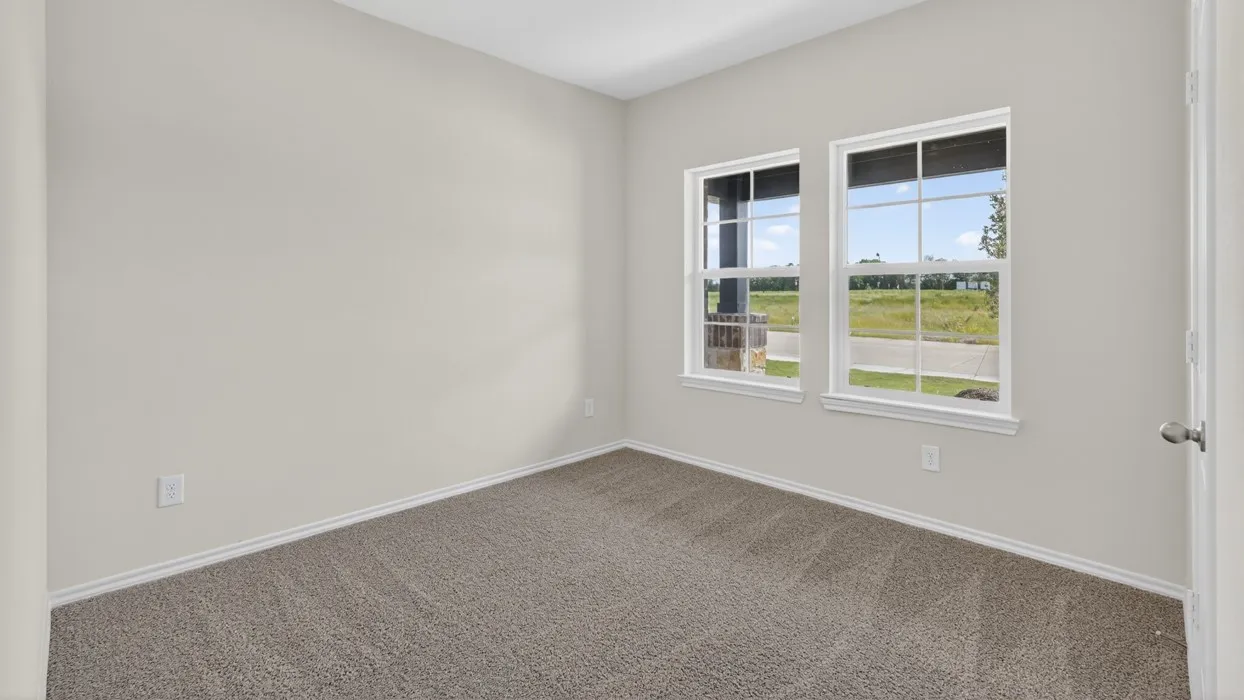 Neutral tone wall paint, dual windows, gray carpet flooring, white trim, and a white door