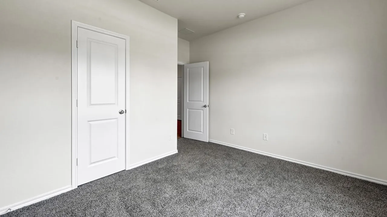 Textured carpeting, white interior doors, and neutral wall finishes