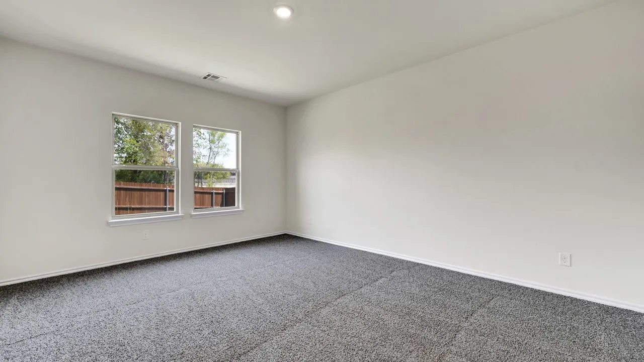 Recessed ceiling light, two windows, and gray carpeted flooring