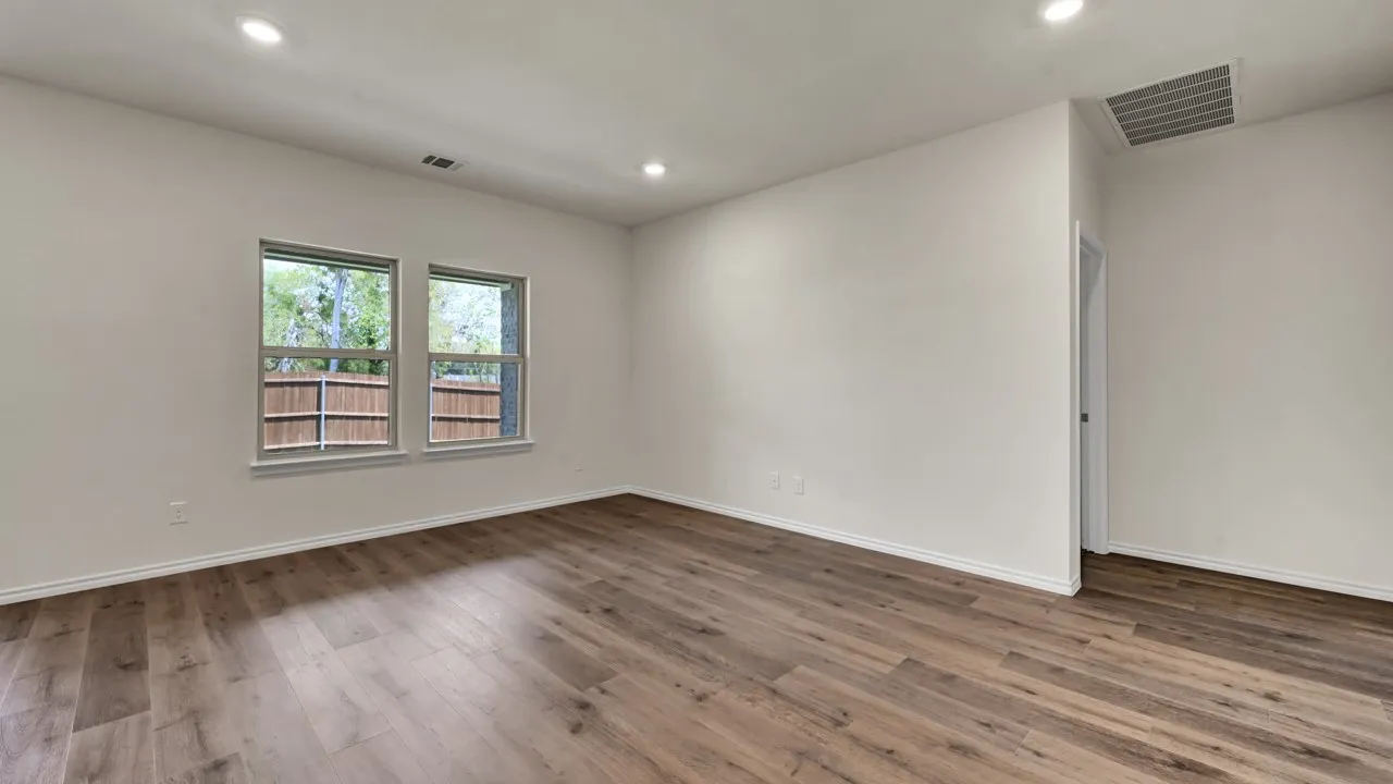 Wood-finish flooring, recessed lighting, and dual windows