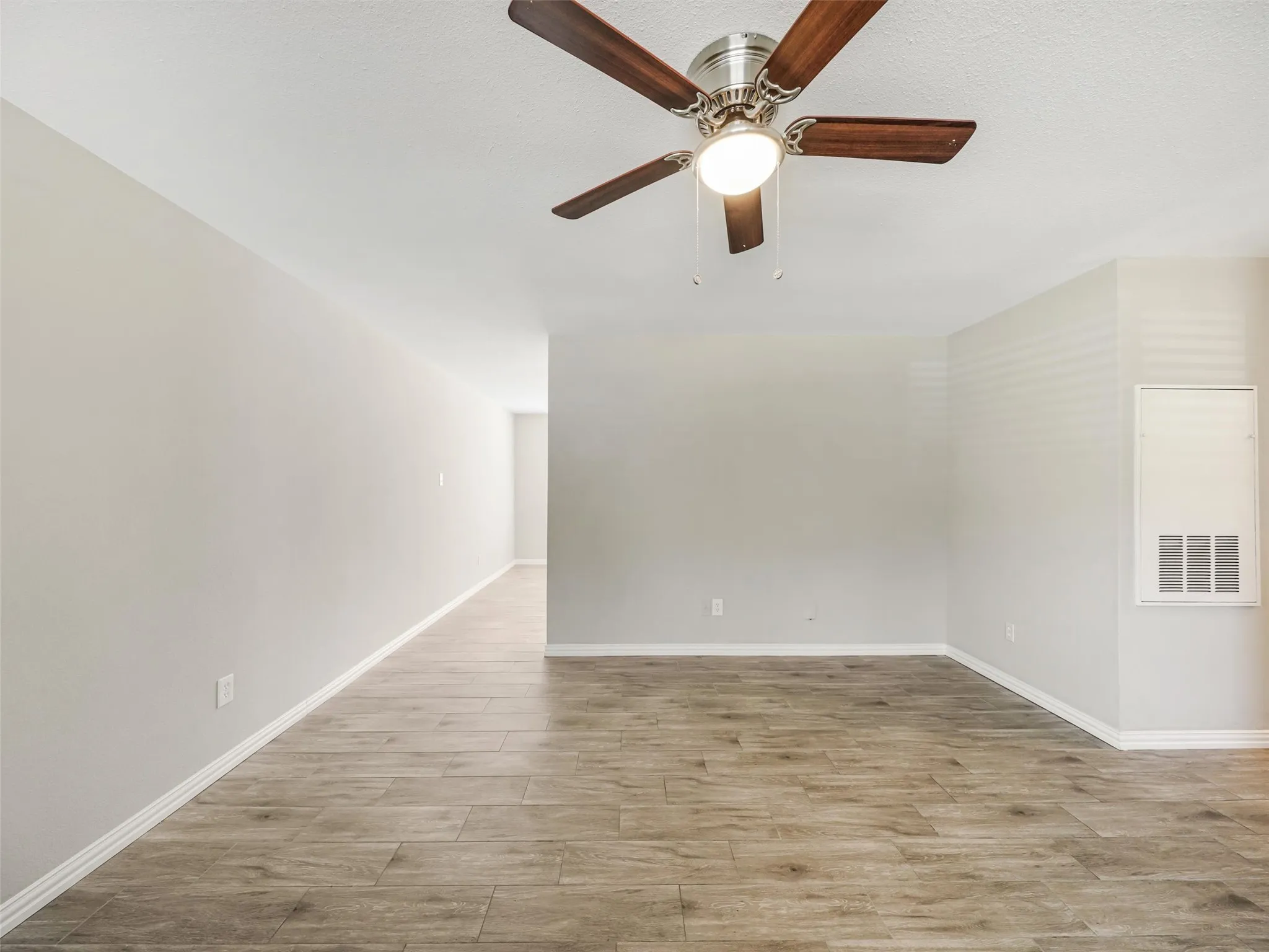 Recessed lighting, wood-finish flooring, ceiling fan with integrated lighting, neutral wall tones, and white trim