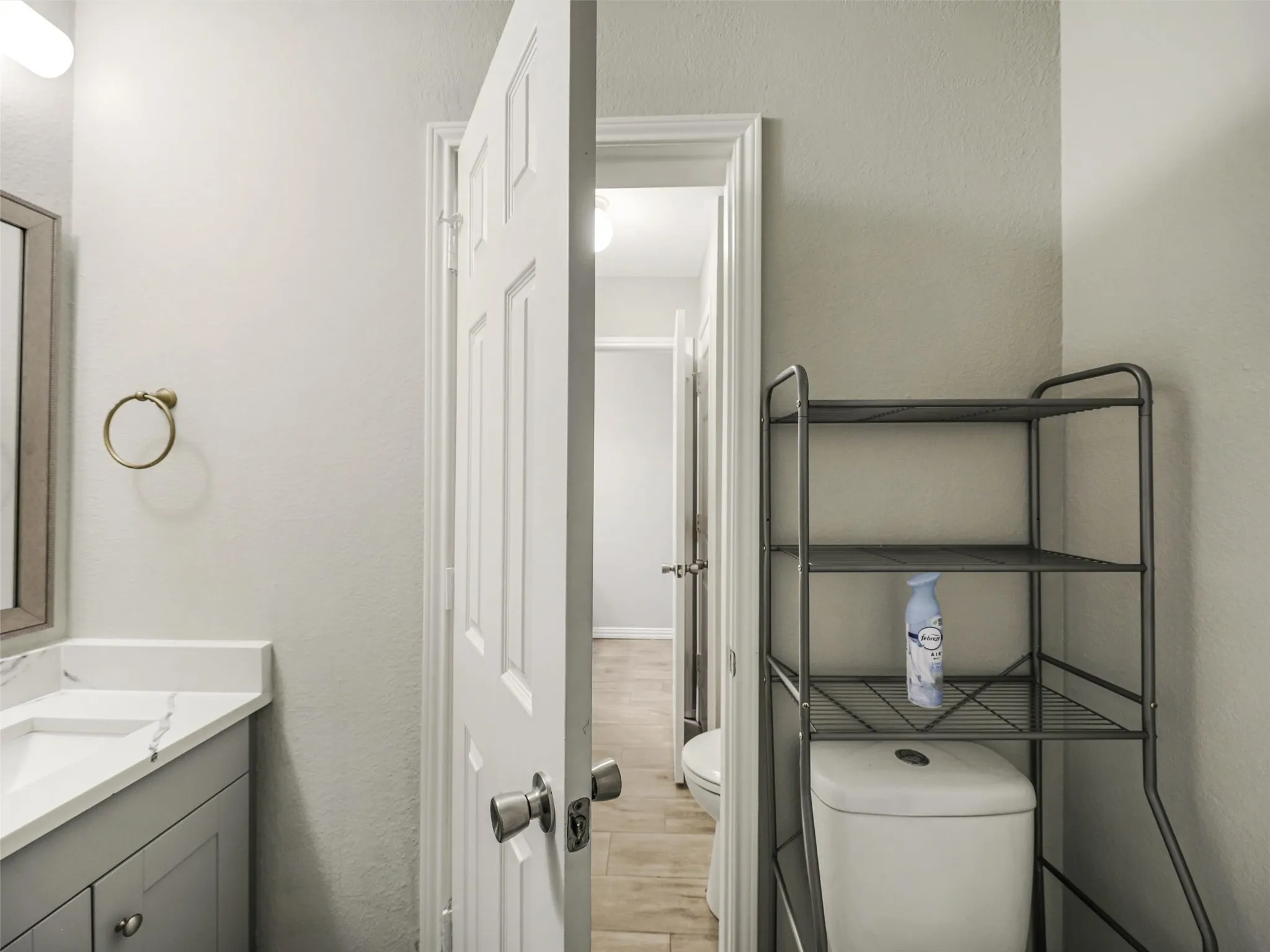 Vanity with integrated sink and countertop, framed mirror, and panel door