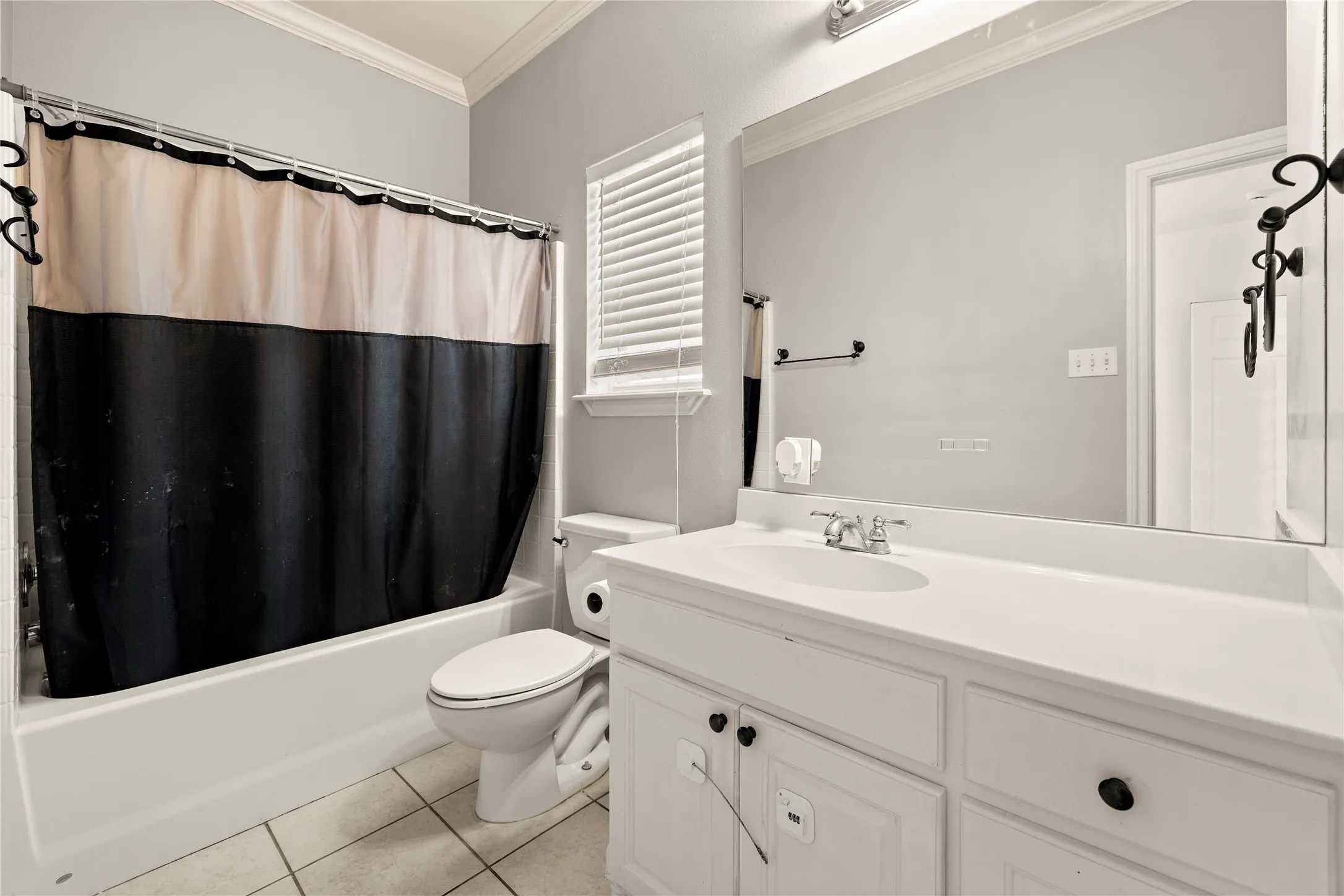 White vanity with panel cabinetry and dark hardware