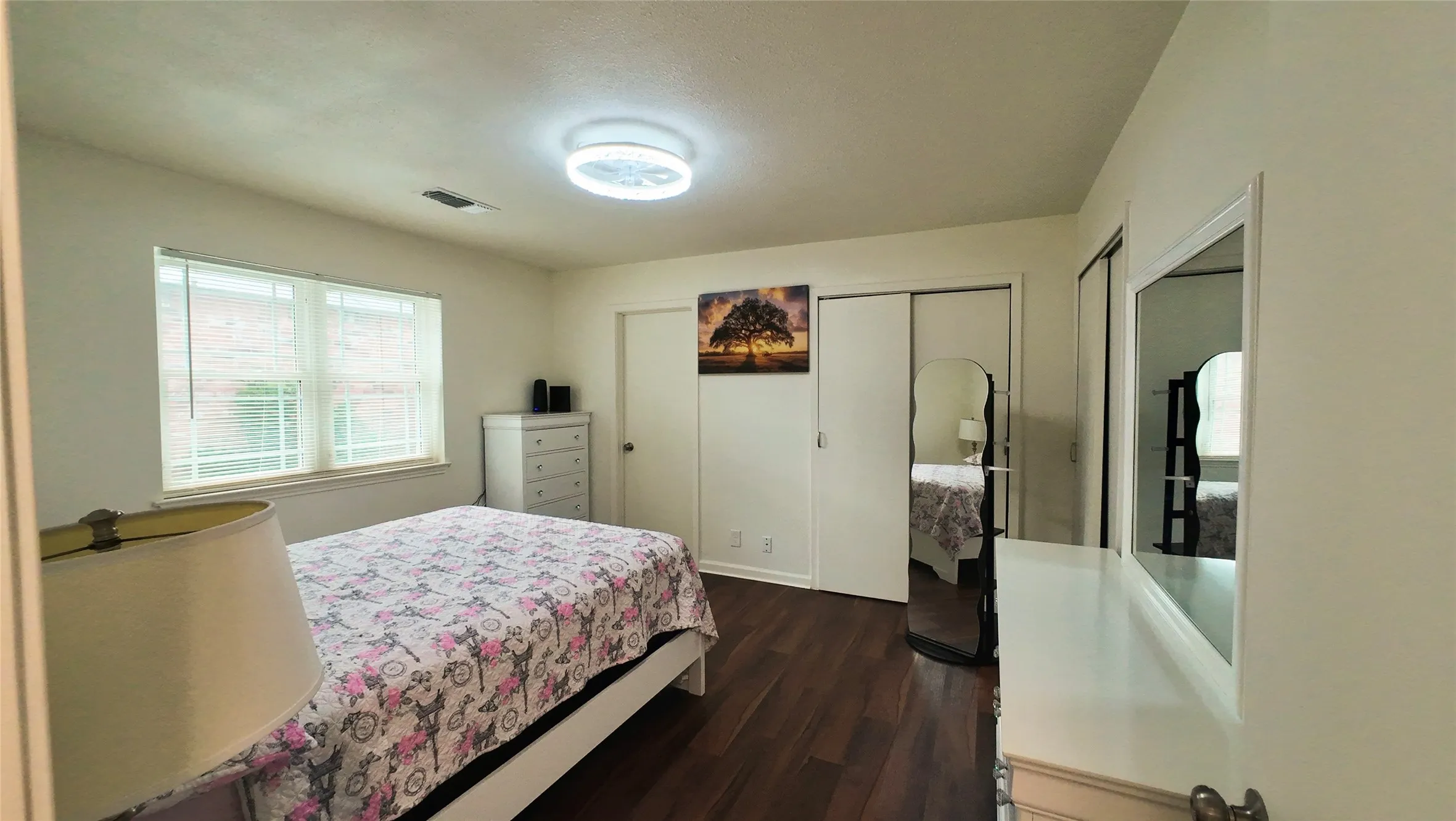 Wood-finish flooring, dual windows, and ceiling-mounted lighting fixture