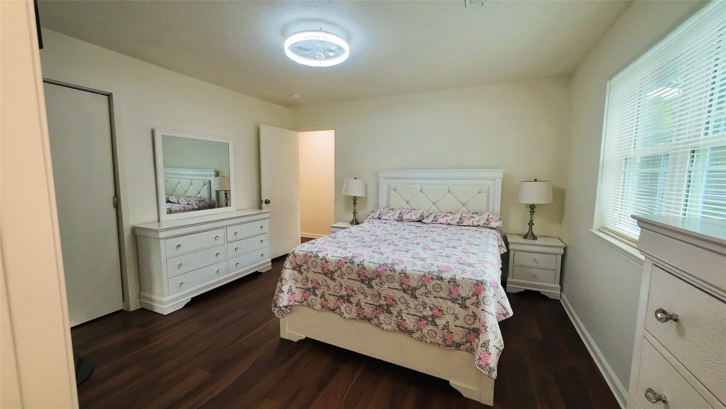 Wood-finish flooring with light cream walls and a ceiling-mounted light fixture