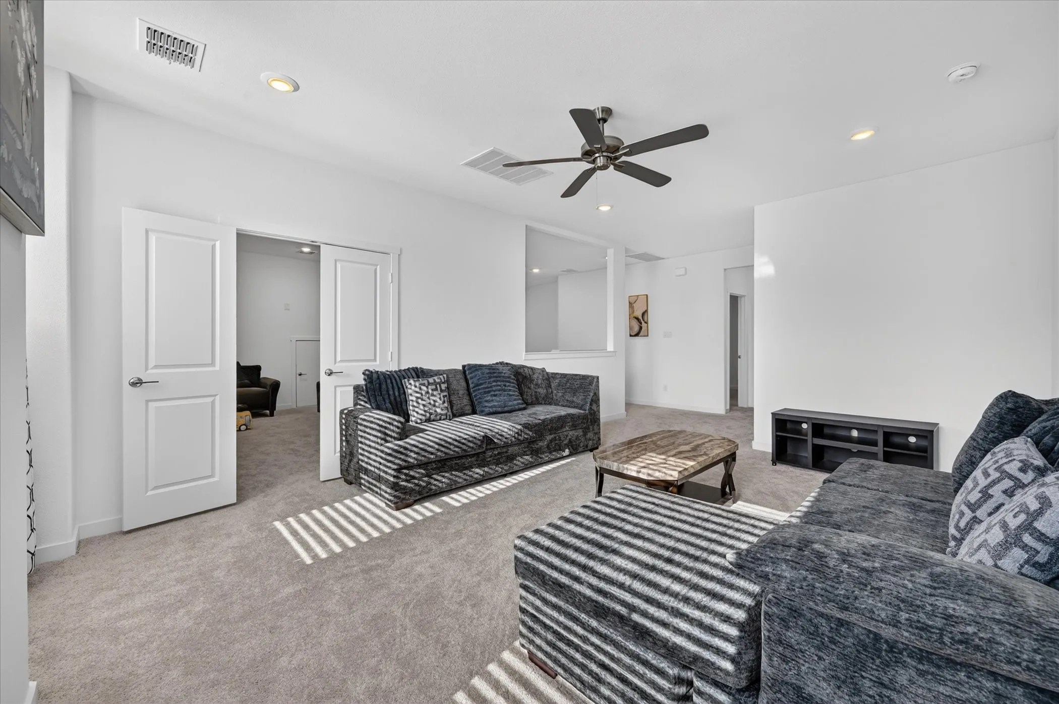 Recessed lighting, ceiling fan, and carpeted flooring