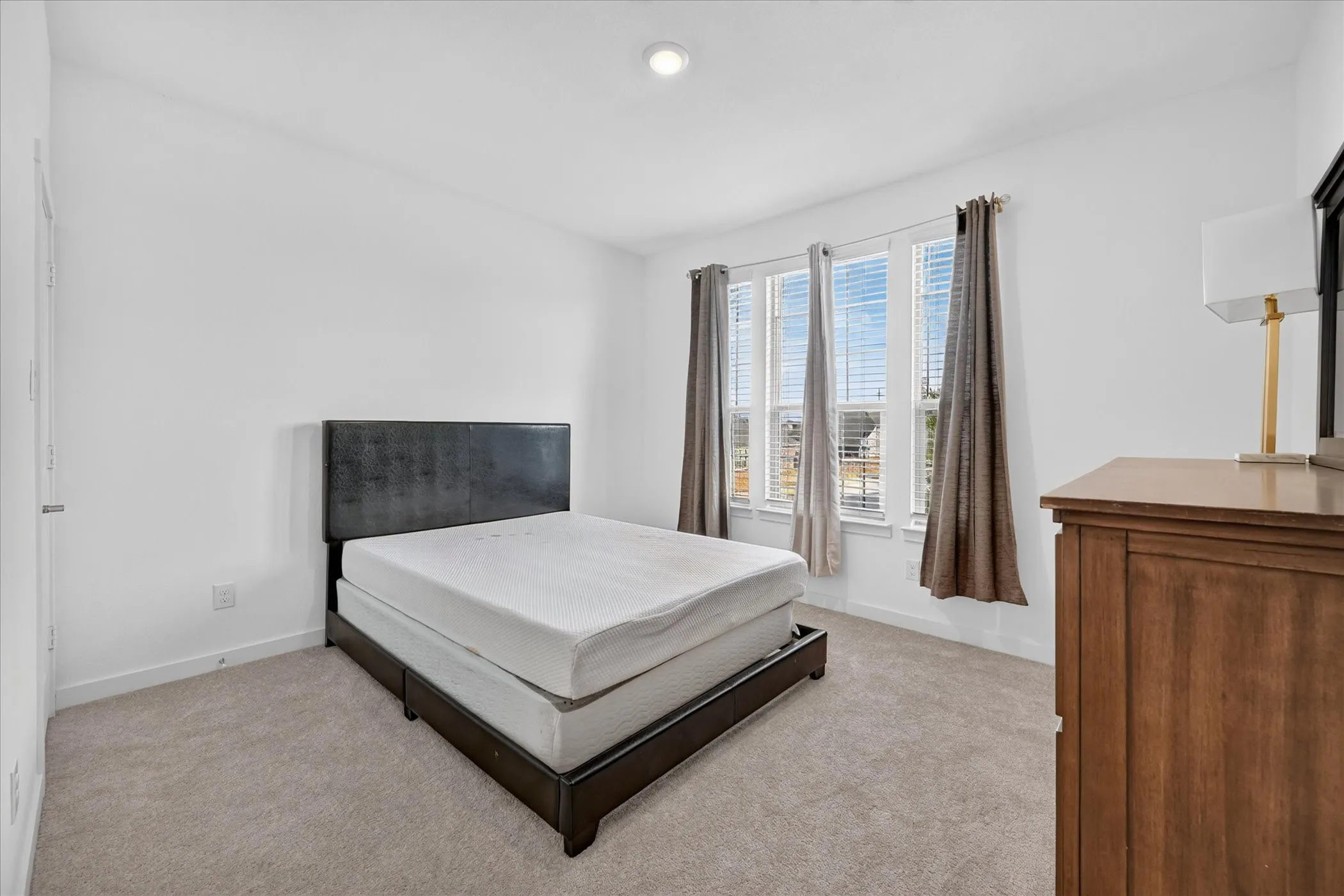 Recessed lighting, light gray carpet flooring, multiple windows with blinds, and white wall finishes