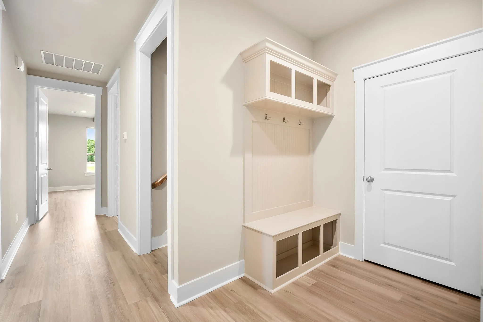 Mud room and under staircase closet with ample storage