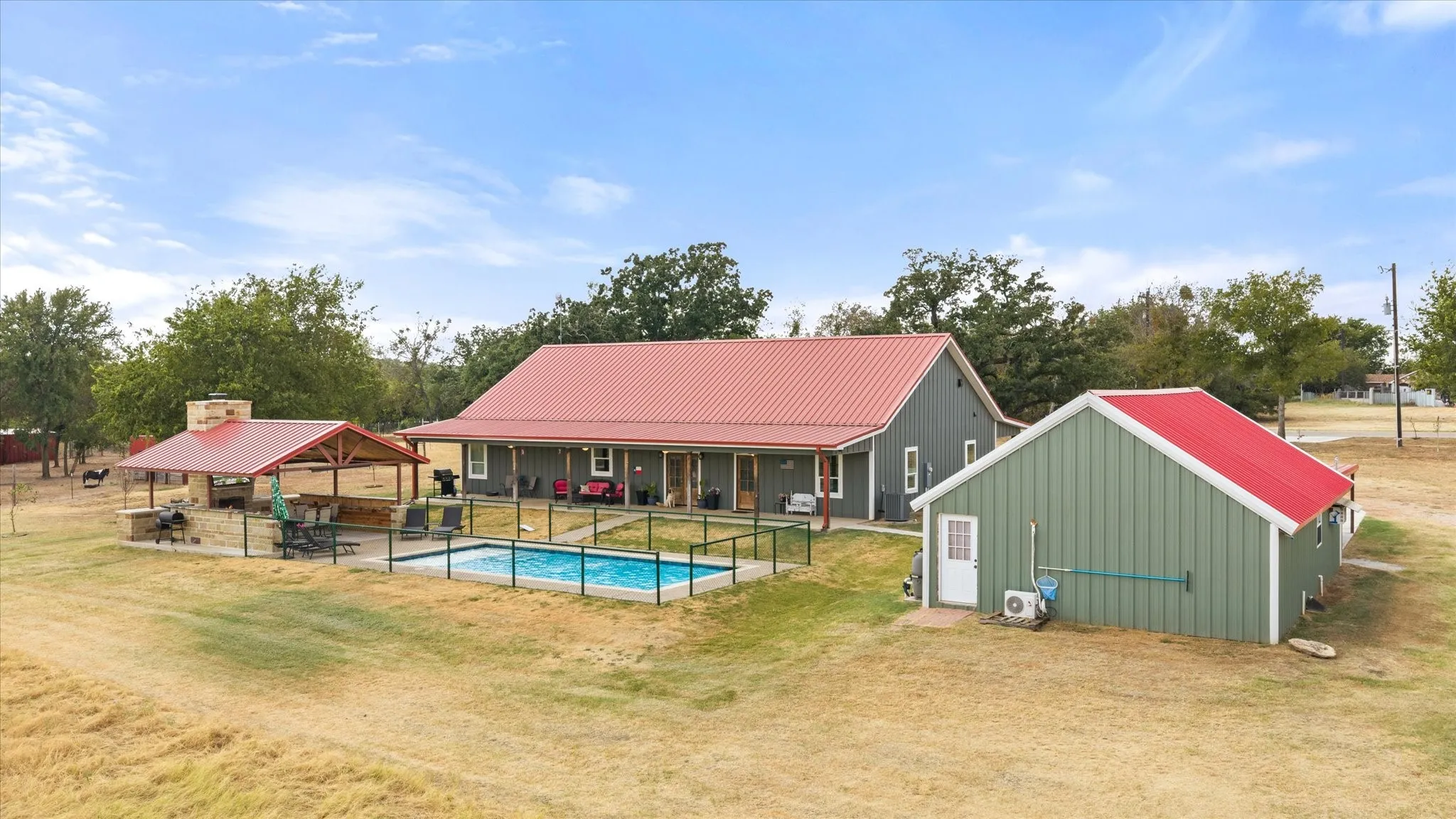 Property includes a covered outdoor kitchen/fireplace, a pool, and a separate apartment.