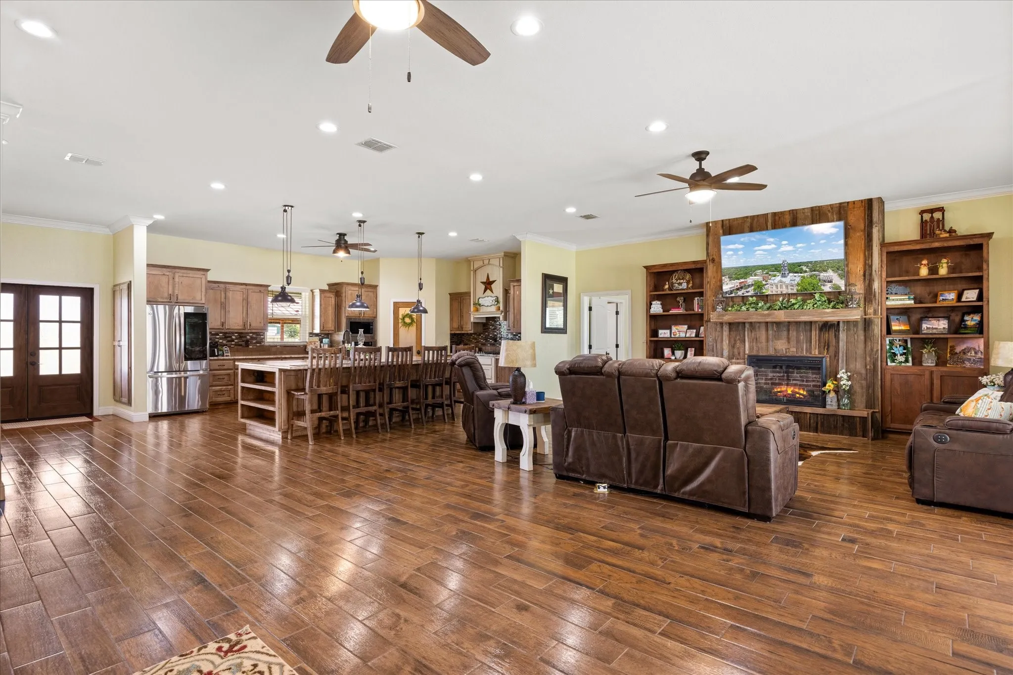 Spacious open living area with an oversized kitchen island and an electric fireplace.