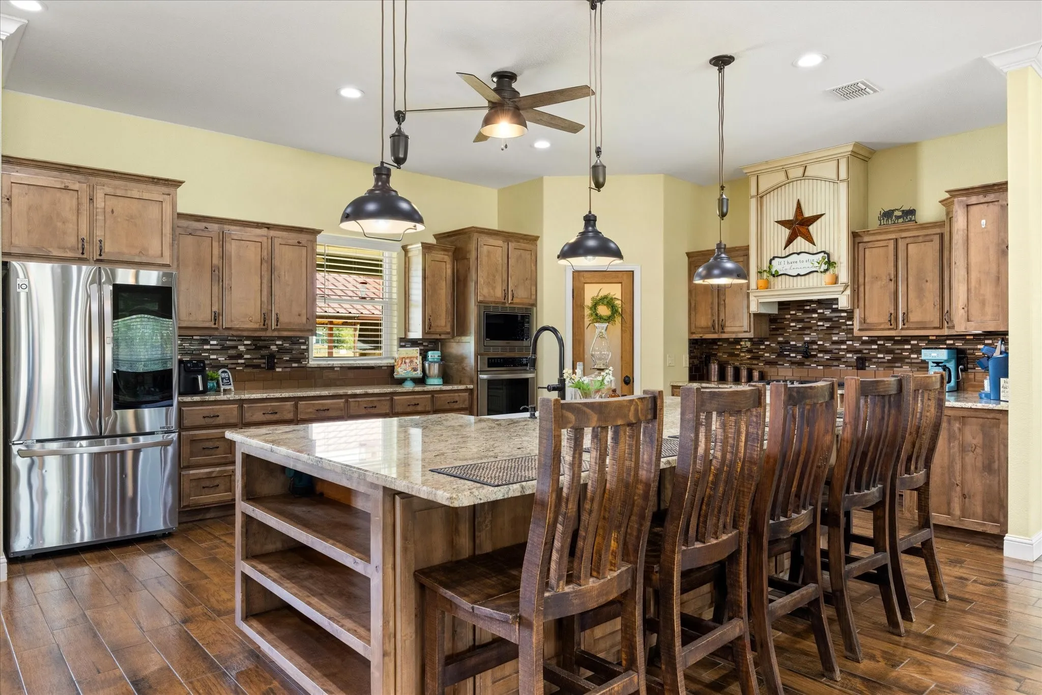Not only is the island oversized, but the space between the island and back cabinets is also oversized, insuring there's room for everyone to help in the kitchen.