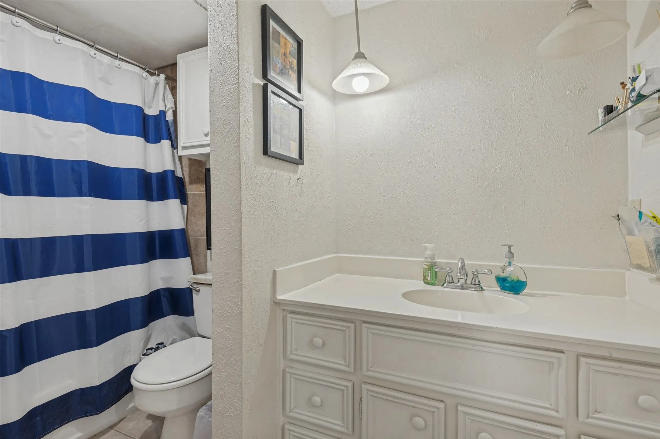 Bathroom with a bath tub combo.