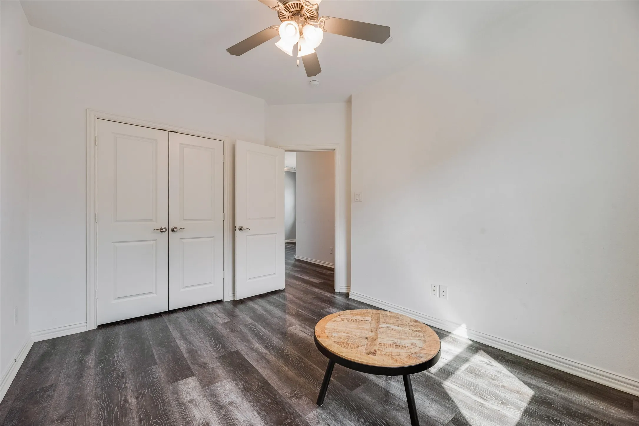 Recessed lighting, ceiling fan with light fixture, wood-finish flooring, white walls, and white paneled doors